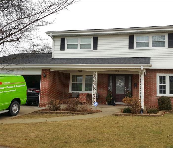 SERVPRO truck in front of house that suffered fire damage